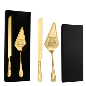 Close-up of golden embossed stainless steel cake knife and server set in black box