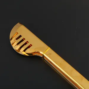Close-up of gold stainless steel kitchen tongs with slotted head design.