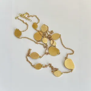 Elegant long necklace featuring brushed gold irregular metal plates in a vintage style.
