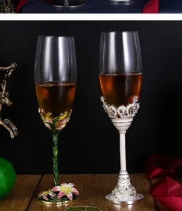 Pair of luxury enamel crystal champagne glasses with elegant floral and pearl relief.