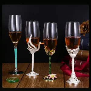 Elegant enamel crystal champagne glasses with swan and lily of the valley reliefs.
