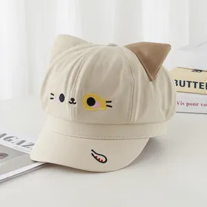 Detail view of beige newsboy cap with cute 3D cat ears and embroidered cat face
