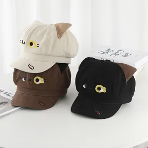 Detailed view of sweet cartoon cat-ear octagonal hats in beige, brown, and black colors