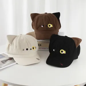 Group of three cute cat-themed newsboy hats in brown, beige, and black with cat ear accents.