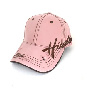 Close-up detail of vintage pink washed baseball cap with brown embroidery and distressing.