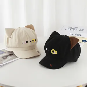 Close-up of sweet and cute cat-themed octagonal hats in beige and black with ear details.