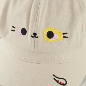 Detailed view of beige cat embroidery on a cotton octagonal sun hat
