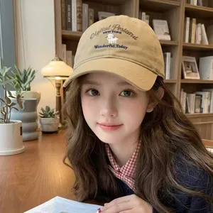 Close-up view of cute sheep cartoon embroidery on a vintage khaki baseball cap for women