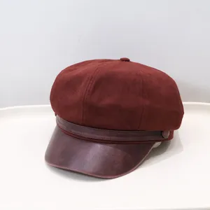 Close-up of a vintage burgundy newsboy cap with PU leather brim and suede crown
