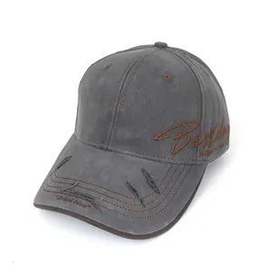 Detail of distressed washed grey baseball cap with brown contrast stitching and side embroidery.