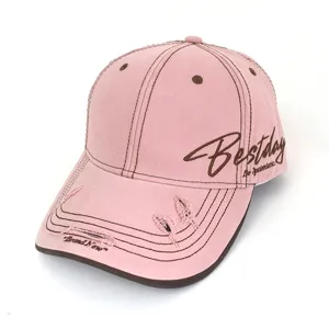 Pink distressed baseball cap detail featuring side embroidery and contrast brown stitching.