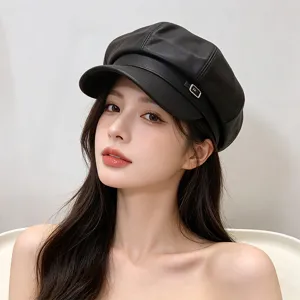 Close-up of a black PU leather newsboy hat with a stylish silver buckle on an Asian model