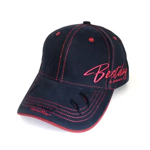 Detailed shot of retro dark baseball cap with red contrast stitching and side embroidery.