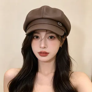 Detailed view of a vintage brown PU leather newsboy hat styled for autumn on a model