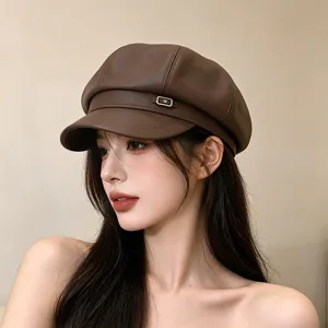 Close-up side view of a stylish retro brown PU leather newsboy cap worn by a female model.