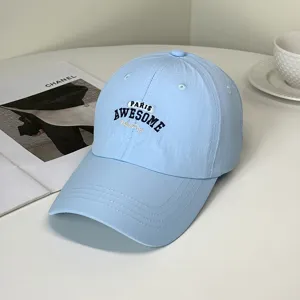 Detailed view of a light blue quick-dry baseball cap with Paris Awesome embroidery.