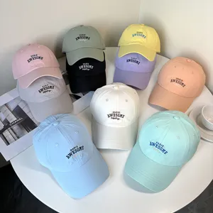 Detailed view of colorful quick-dry baseball caps with embroidered PARIS AWESOME text