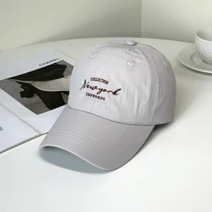 Close-up detail of a stylish light gray baseball cap with New York letter embroidery