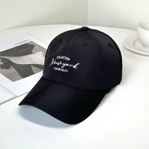 Macro detail showing white New York letter embroidery on a black quick-dry baseball cap