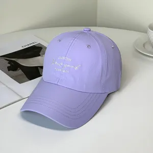 Detailed macro view of a lavender purple baseball cap featuring white New York embroidery