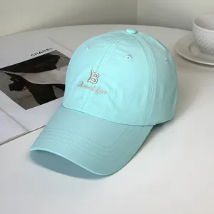 Fashionable mint blue baseball cap with Brooklyn embroidery shown from a side angle