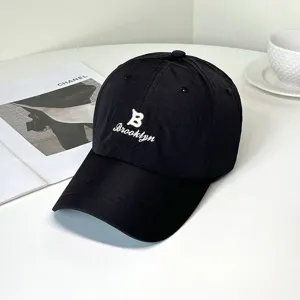 Close-up of a black quick-dry baseball cap with white Brooklyn embroidery details