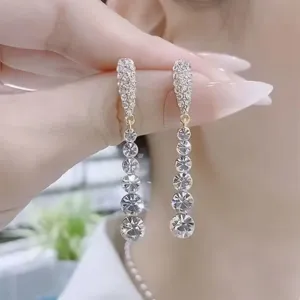 Detailed macro shot of sparkling long tassel earrings featuring multiple brilliant crystals