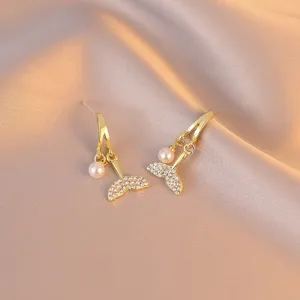 Elegant mermaid tail drop earrings with small pearls and crystals on satin background
