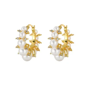 Detail view of gold-tone French vintage hoop earrings with elegant white pearls and crystals
