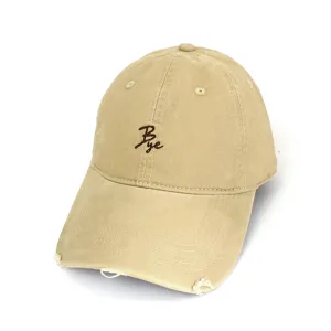 Detailed view of a casual beige washed baseball cap with brown embroidered letter Bye.