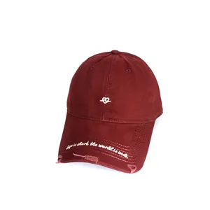 Close-up of vintage burgundy baseball cap with white heart and text embroidery