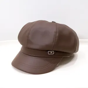 Detailed view of a vintage brown PU leather newsboy hat featuring a small metal buckle