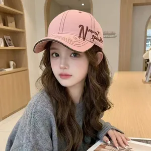Chic pink baseball cap with stylish side embroidery, perfect for outdoor fashion and sun protection.