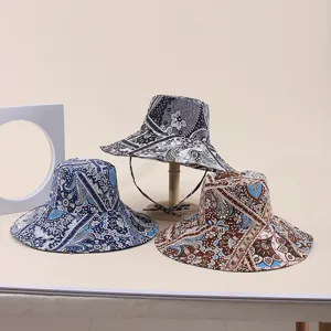 Collection of wide-brimmed sun hats featuring vibrant bohemian paisley print patterns