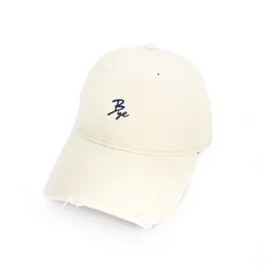 Distressed beige baseball cap featuring a stylish navy cursive 'Bye' embroidery on the front.
