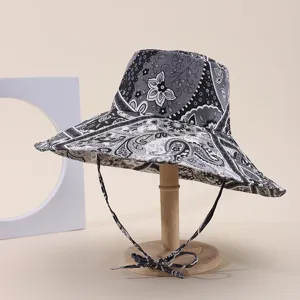 Detailed view of the intricate paisley and floral print on a wide-brim sun hat