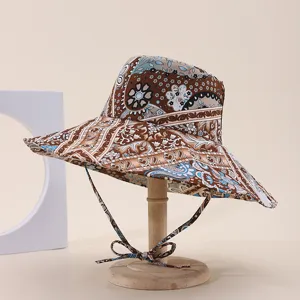 Detailed view of the foldable outdoor sun hat with ethnic floral prints and a windproof strap