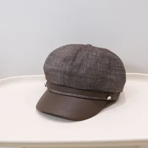 Vintage British newsboy hat with brown textured fabric and faux leather brim detail