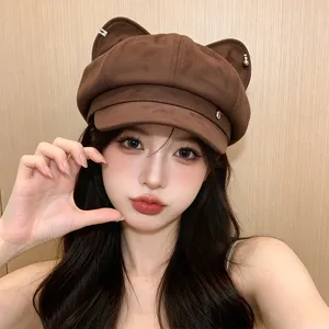 Detailed close-up shot of a cute brown cat ear newsboy hat worn by model, soft texture.