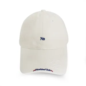 Detailed view of beige casual baseball cap featuring stylish embroidered NB and lettering design.