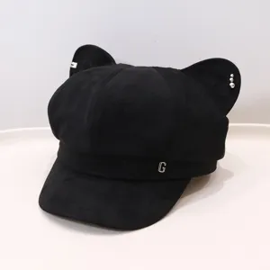 Detail view of the black cat ear octagonal painter hat, showcasing metal decoration and texture.