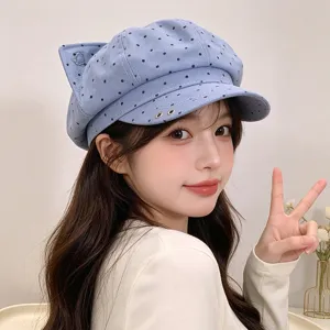 Detailed view of the cute blue polka dot cat ear newsboy cap, soft texture and chic design.