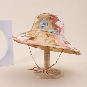 Close-up of wide-brim floral sun hat with adjustable chin strap for travel