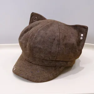 Brown polka dot cat ear newsboy hat detail view, cute metallic heart and stud accents.