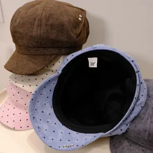 Detailed view of fashionable polka dot newsboy caps in multiple colors for autumn and winter.