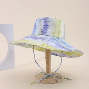 Detailed side view of tie-dye wide brim sun hat with matching chin strap bow