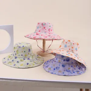 Detailed view of colorful printed sun hats with wide brims and adjustable chin straps.