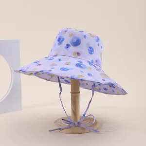 Detailed close-up view of purple polka dot print on the foldable wide-brim sun hat.