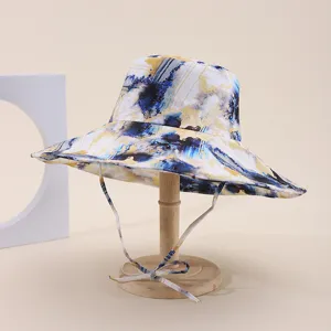 Close-up of wide-brim fisherman hat with abstract blue and yellow ink-wash print pattern