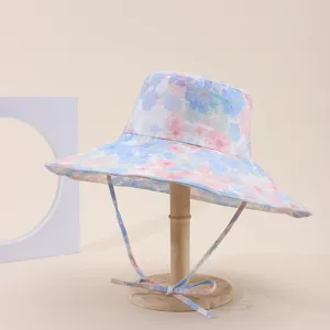 Wide brim floral print sun hat on a wooden stand for outdoor sun protection and travel
